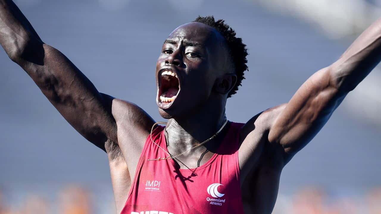 Gout Gout raising his arms after winning the U18s, 100m final during the Australian All Schools Athletics Championships