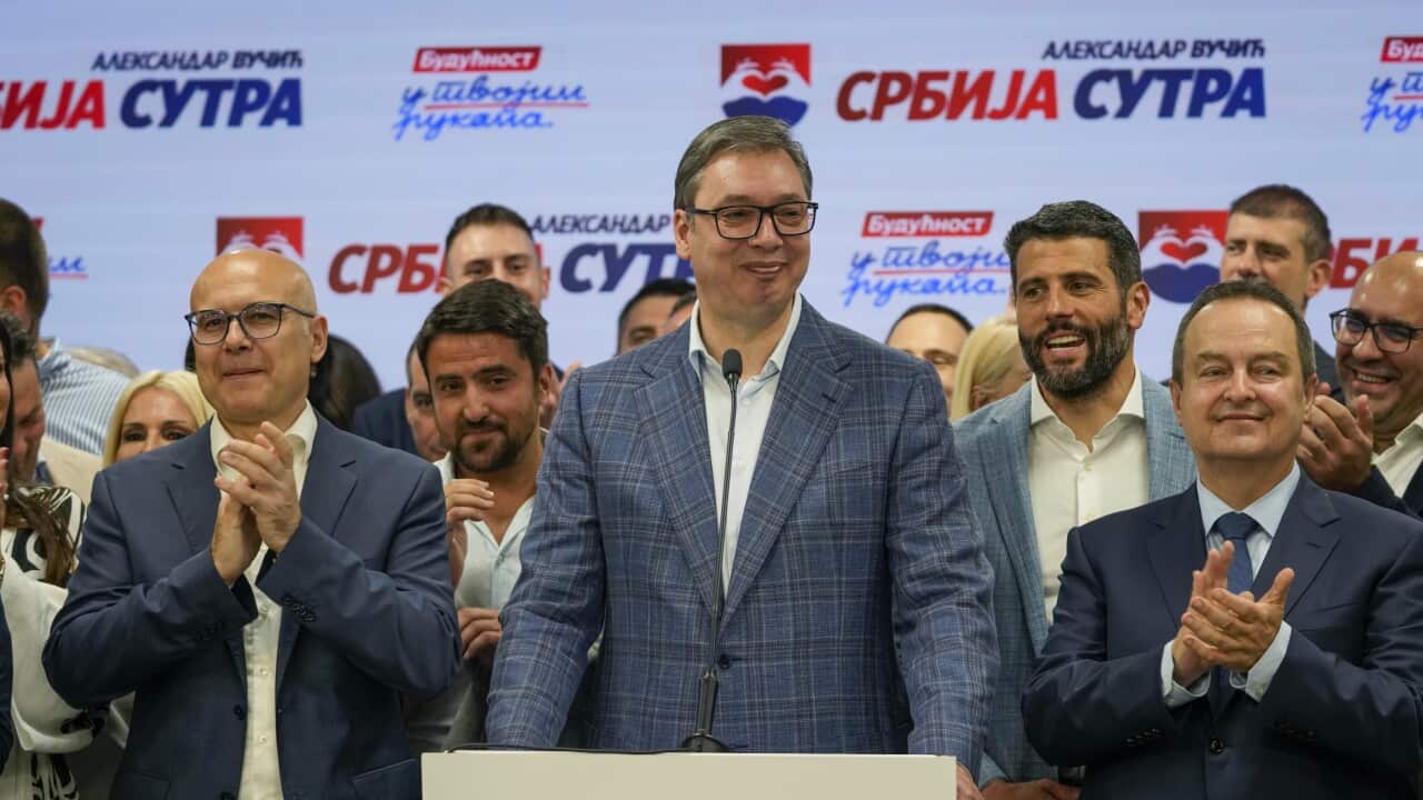 Serbian President Aleksandar Vucic smiles while speaking at his party's headquarters during local elections in Belgrade