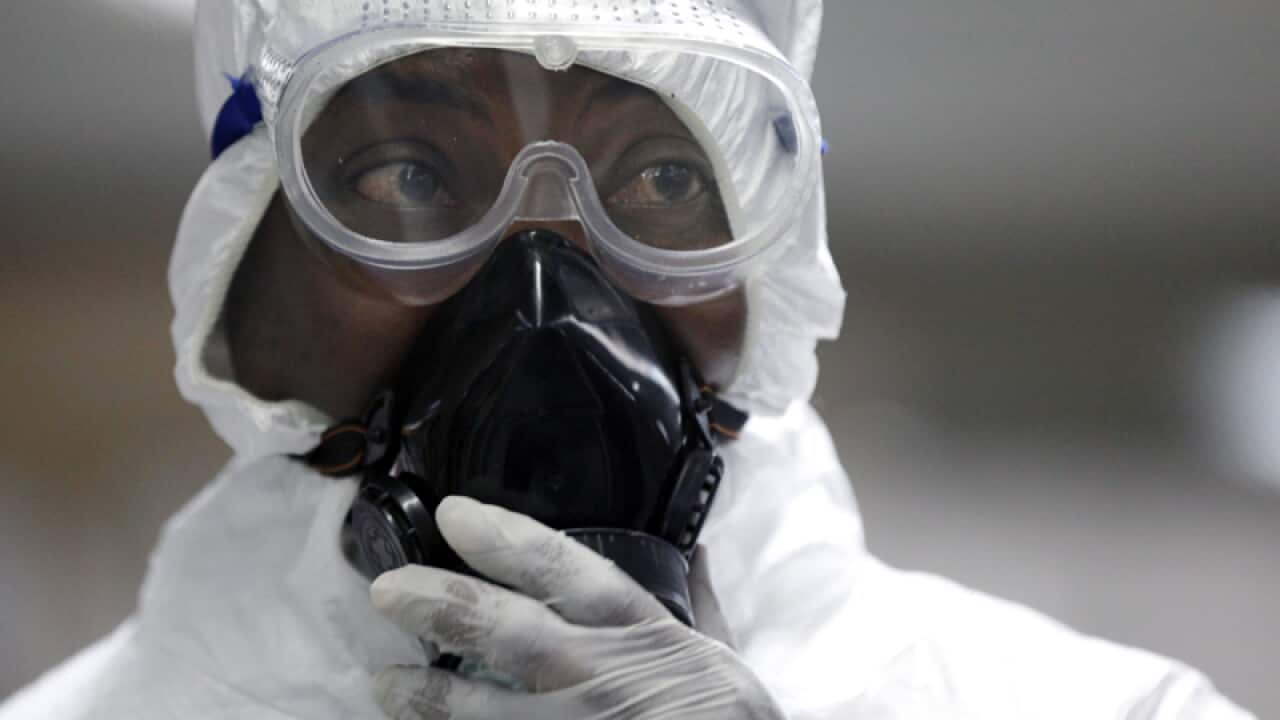 A Nigerian health official wearing a protective suit in Lagos