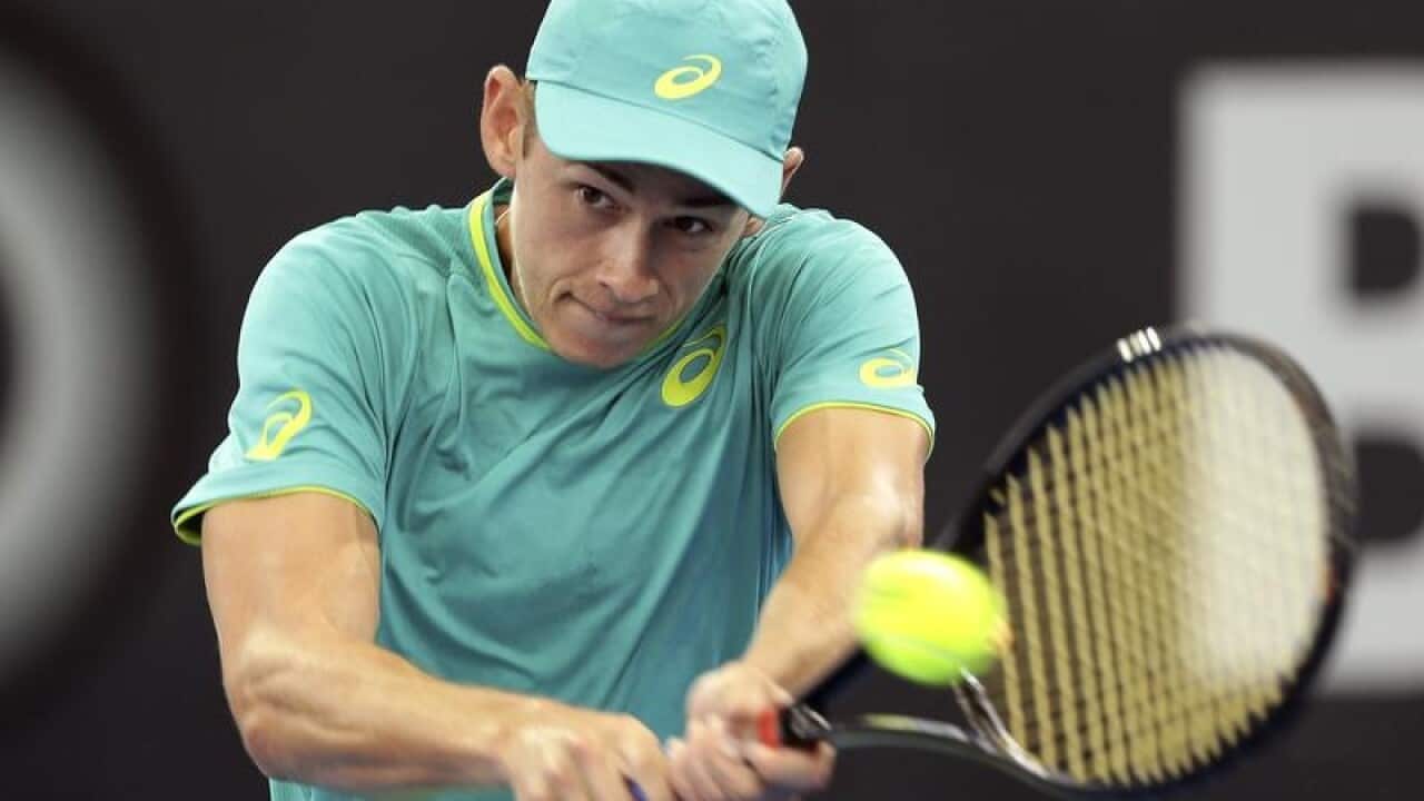Alex De Minaur of Australia plays a shot in his quarter final match