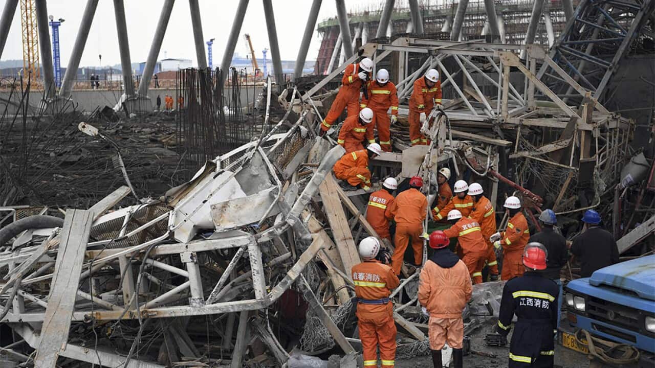 Rescue workers look for survivors after a work platform collapsed at the Fengcheng power plant in eastern China's Jiangxi Province