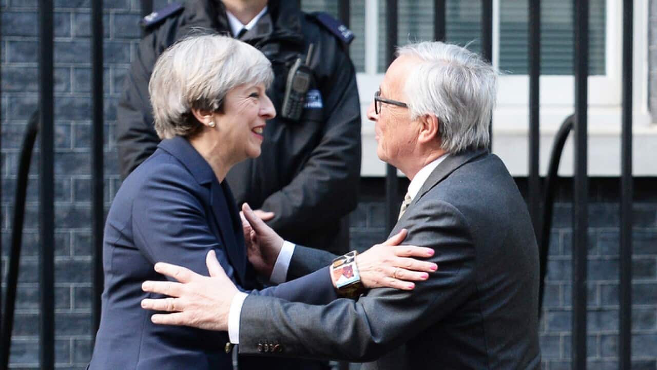 Theresa May greeting Jean-Claude Juncker