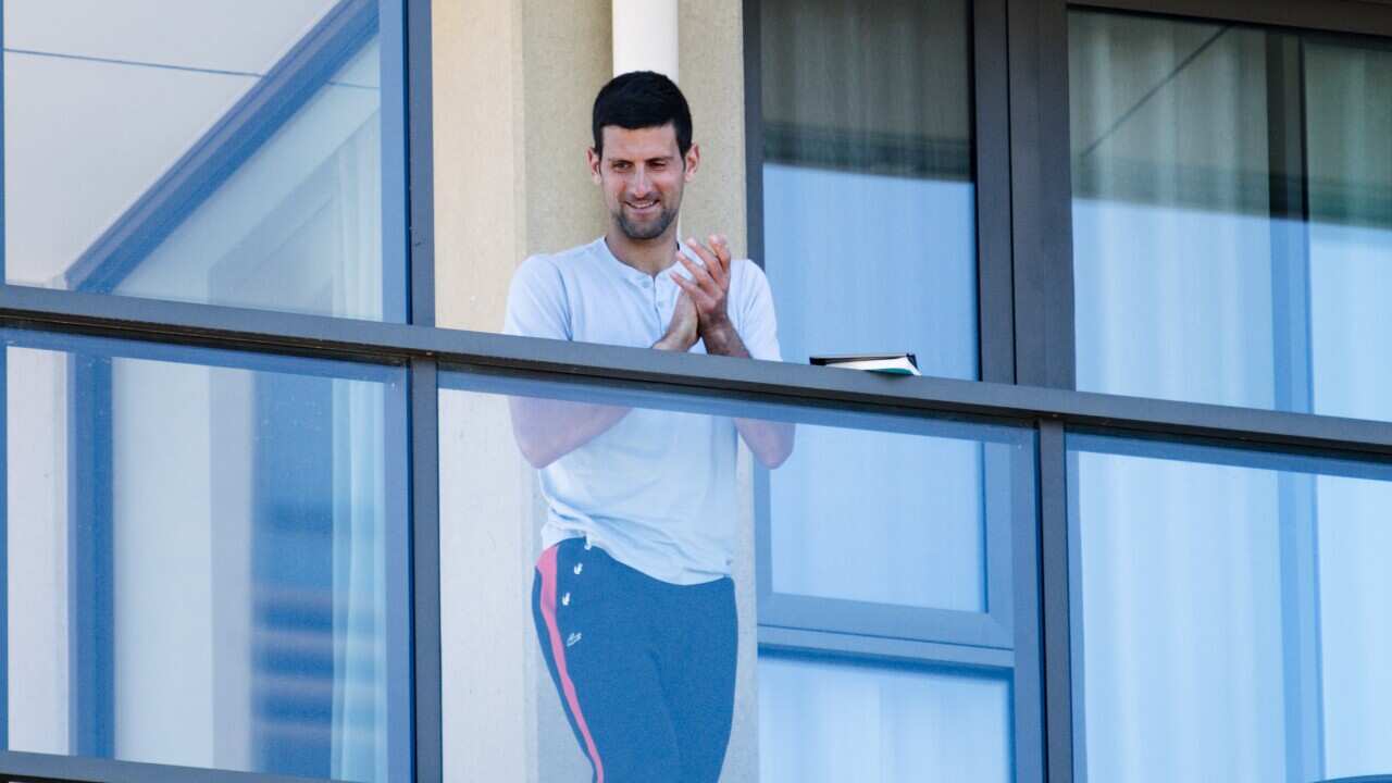 Tennis star Novak Djokovic is seen on the balcony of hotel quarantine accommodation in North Adelaide