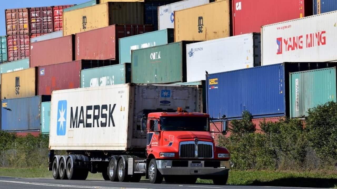 A truck transporting a shipping container