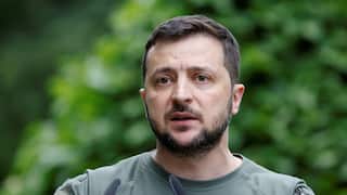 Ukraine President Volodymyr Zelenskyy speaking into microphones