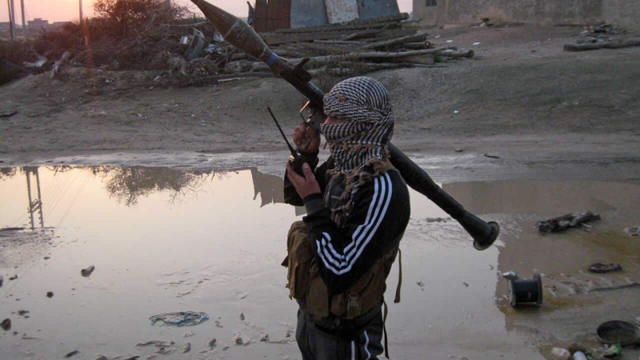 A gunman holds his weapon in Fallujah