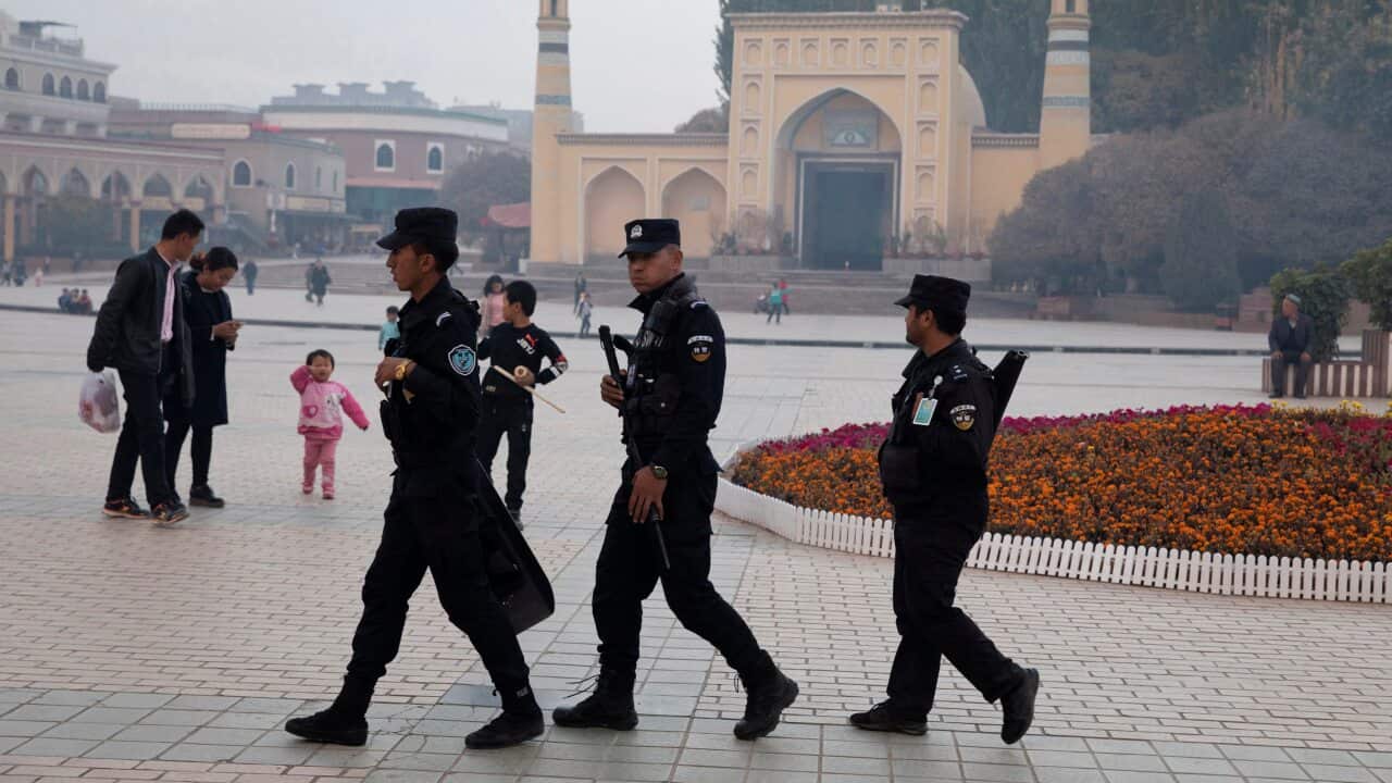 Uighur security personnel patrol near the Id Kah Mosque in Kashgar in western China's Xinjiang region.
