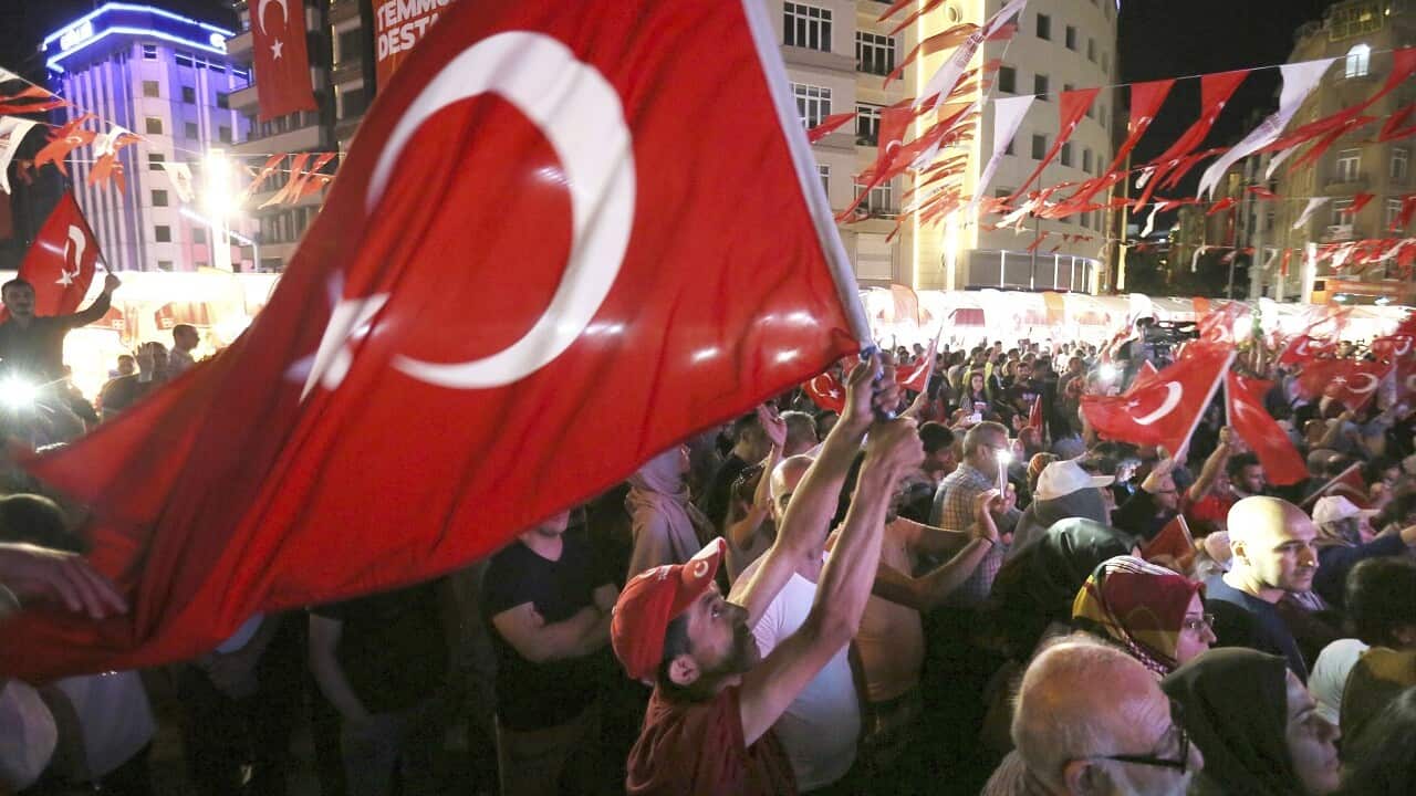 People wave the Turkish national flag to commemorate the one year anniversary of the failed coup in Istanbul on July 13, 2017.