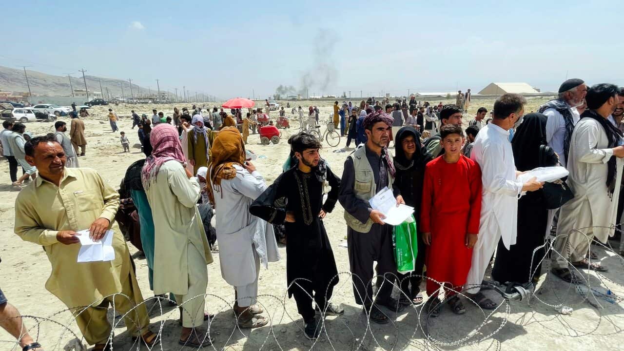 Hundreds of people at the international airport in Kabul, Afghanistan, Monday, Aug. 16, 2021.