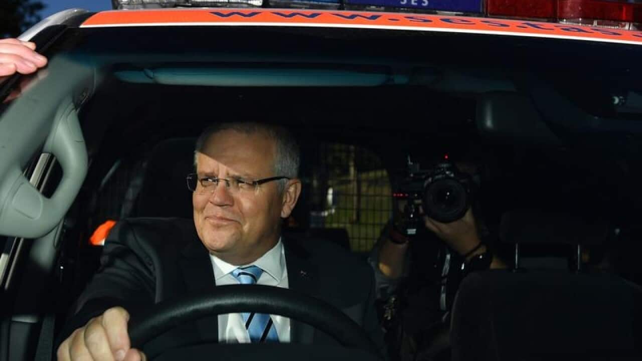 Prime Minister Scott Morrison at wheel of car.