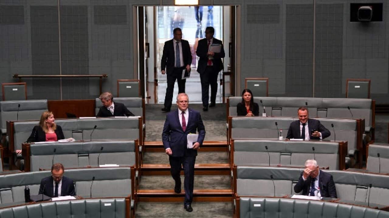 Prime Minister Scott Morrison arrives during Question Time under rules of social distancing in the House of Representatives at Parliament House , 23 March 2020