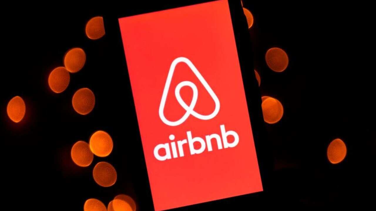 The logo of the online lodging service Airbnb displayed on a mobile phone.