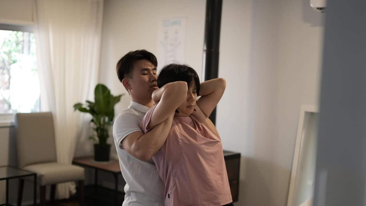 Ben giving his mother a chiropractic treatment