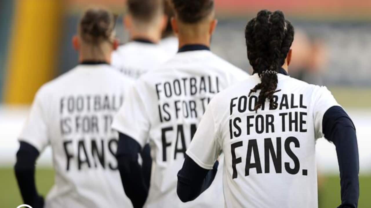 Leeds United players wearing 'Football Is For The Fans' shirts ahead of a match with Liverpool