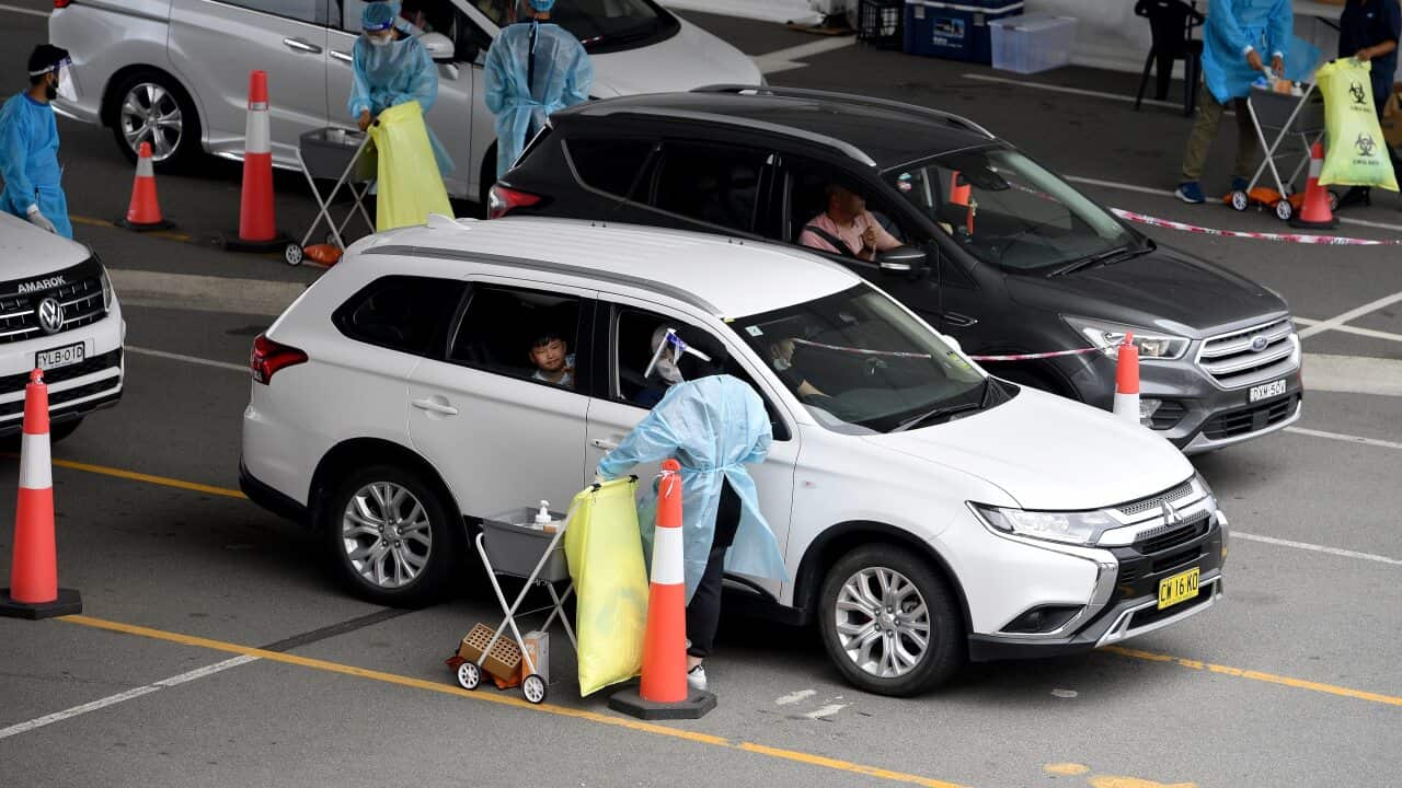 Cars queue as people wait to recieve a Covid test at a drive through testing facility at Sydney International Aiport, in Sydney, Wednesday, December 22, 2021. (AAP Image/Dan Himbrechts) NO ARCHIVING