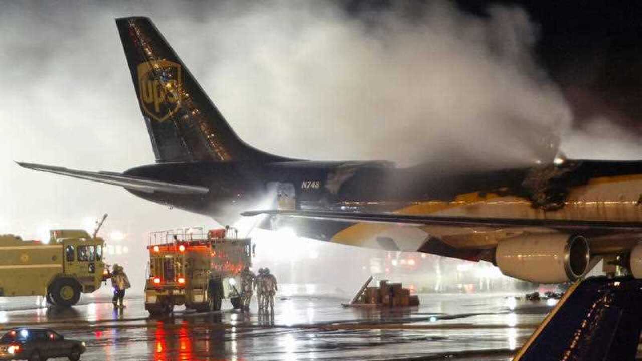 In this Feb. 8, 2006 file photo, firefighters battle a blaze onboard a UPS cargo plane at Philadelphia International Airport in Philadelphia.