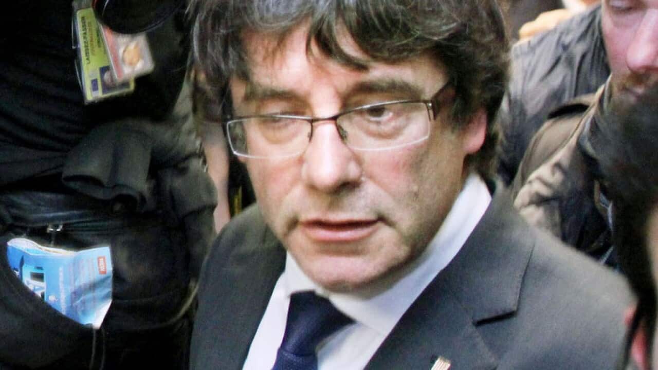 Ousted Catalan leader Carles Puigdemont leaves a press conference in Brussels