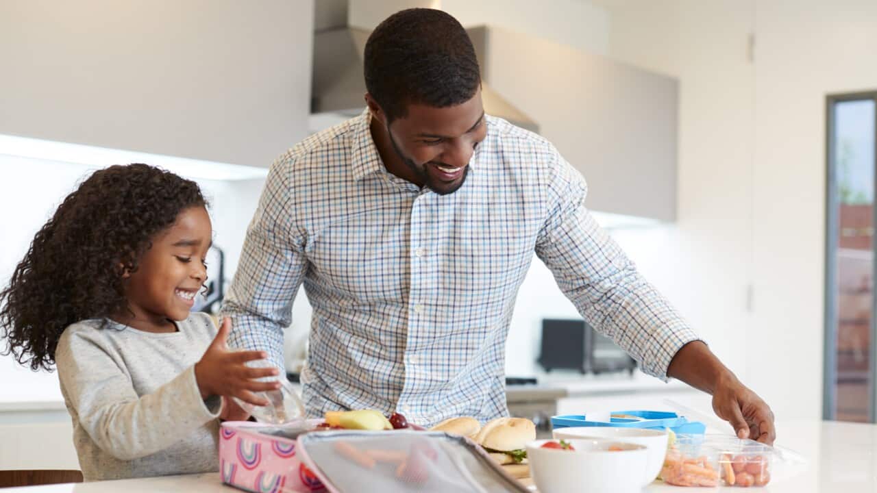 Father and daughter making school lunch