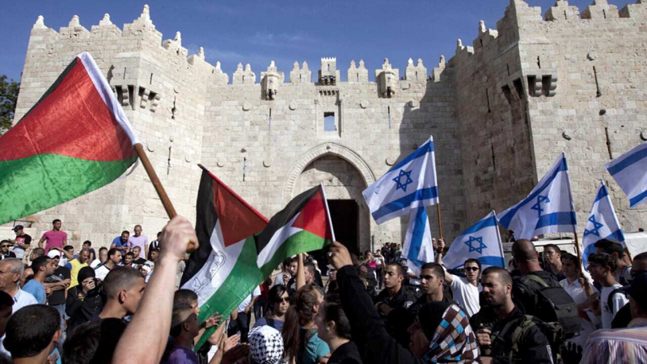 Israelis and Palestinians wave flags on Jerusalem Day