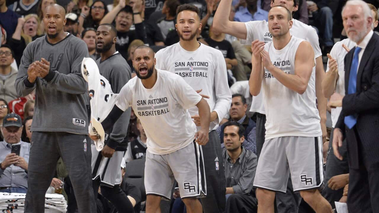 The San Antonio Spurs bench celebrates a basket by Spurs