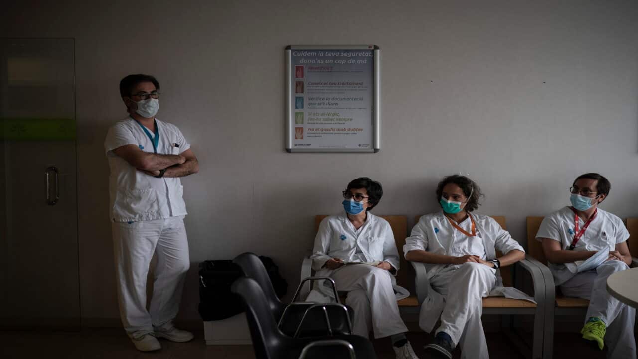 Healthcare workers gather during meeting to discuss COVID-19 procedures in Barcelona, Spain.