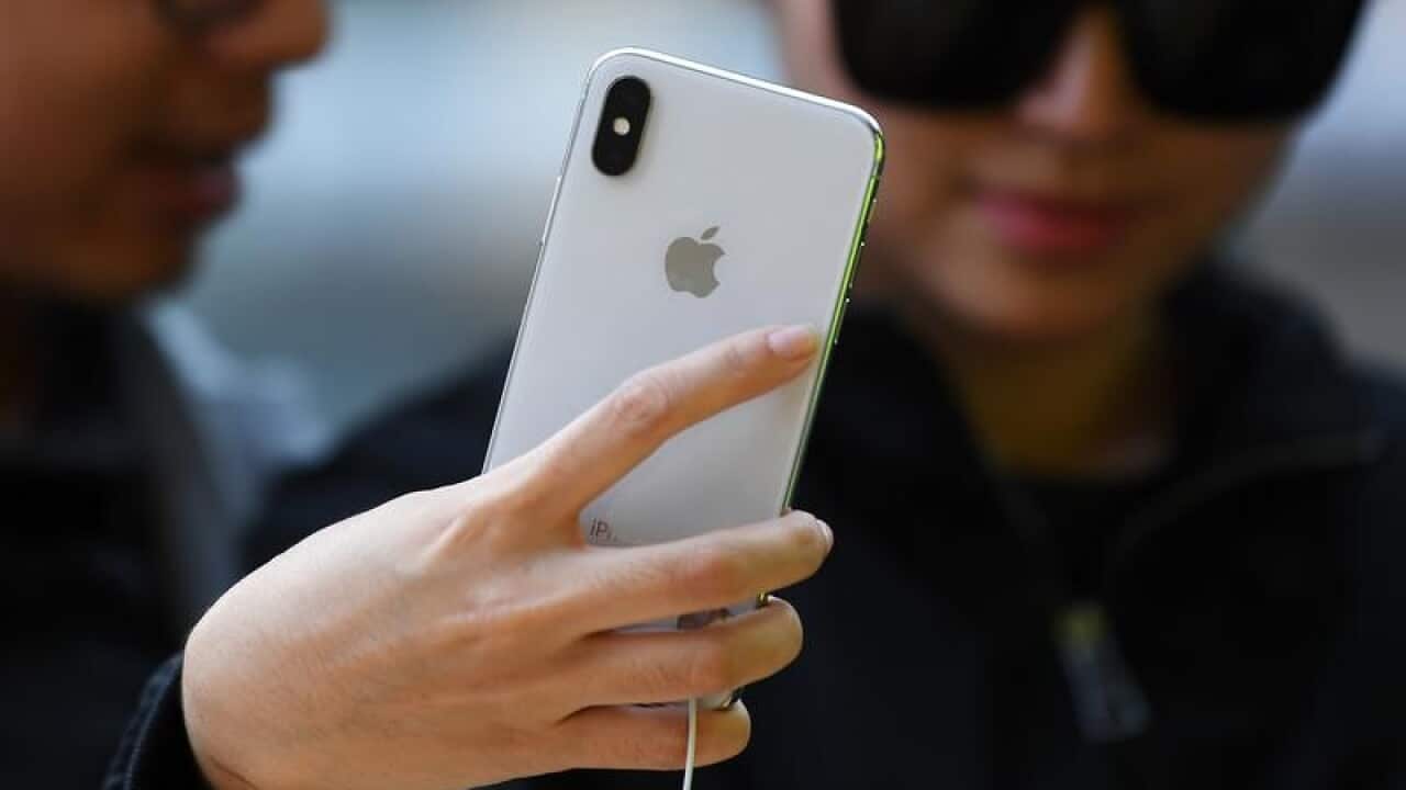People look at the iPhone X.