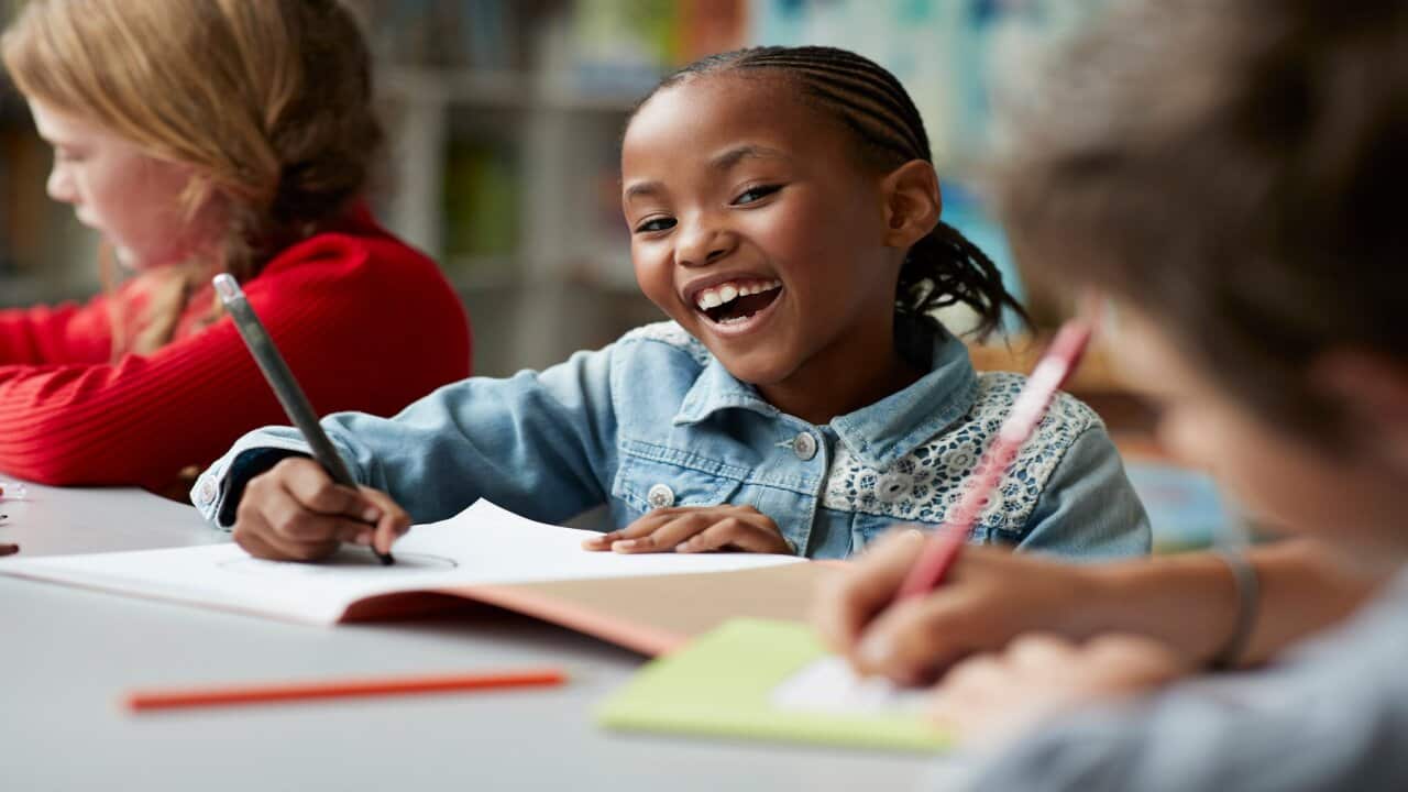 School children laughing at modern school facility
