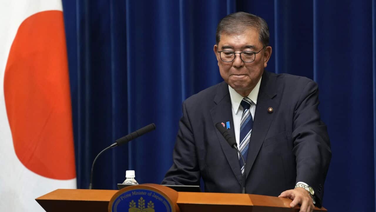 Japan's Prime Minister Ishiba standing behind podium to resign