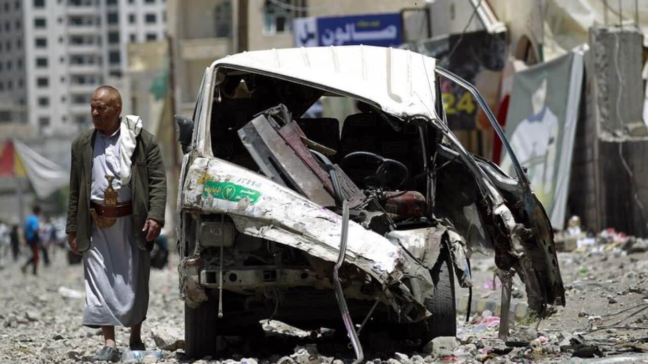 A vehicle damaged in a strike by Saudi-led coalition planes in the Yemeni capital Sanaa