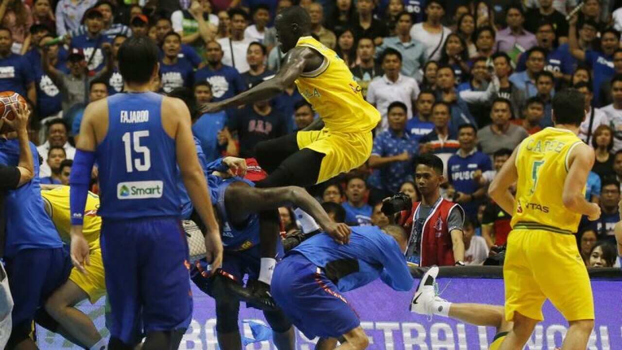 Thon Maker attempts to kick a Philippines basketball player.