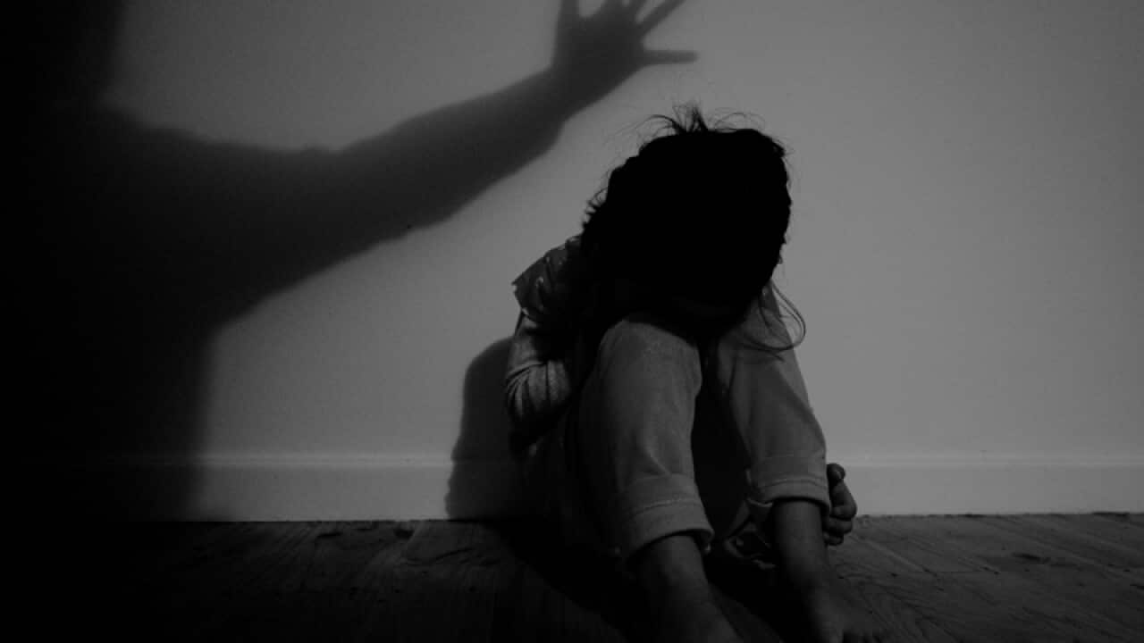 A little girl poses for photographs to illustrate child abuse