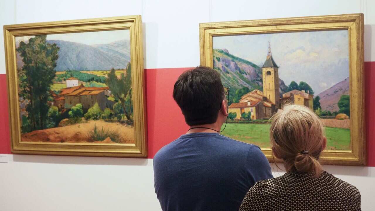 Visitors look at the painting "Le clocher de Ria" at the museum dedicated to French painter Etienne Terrus, in Elne (Elna).