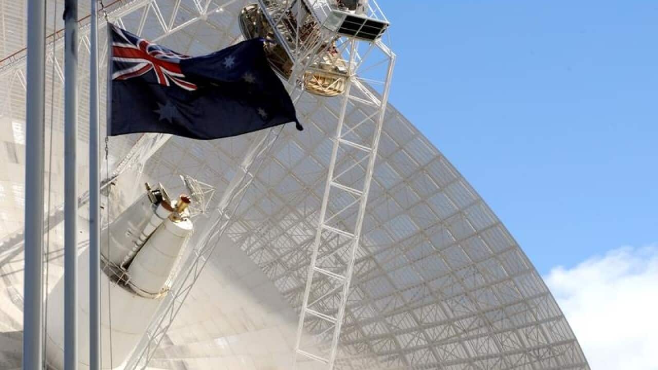 The Australian flag flies in front of Space station dish No. 43.