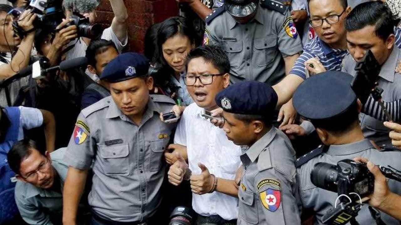 Reuters journalist Wa Lone is escorted out of the Insein township court in Yangon, Myanmar.