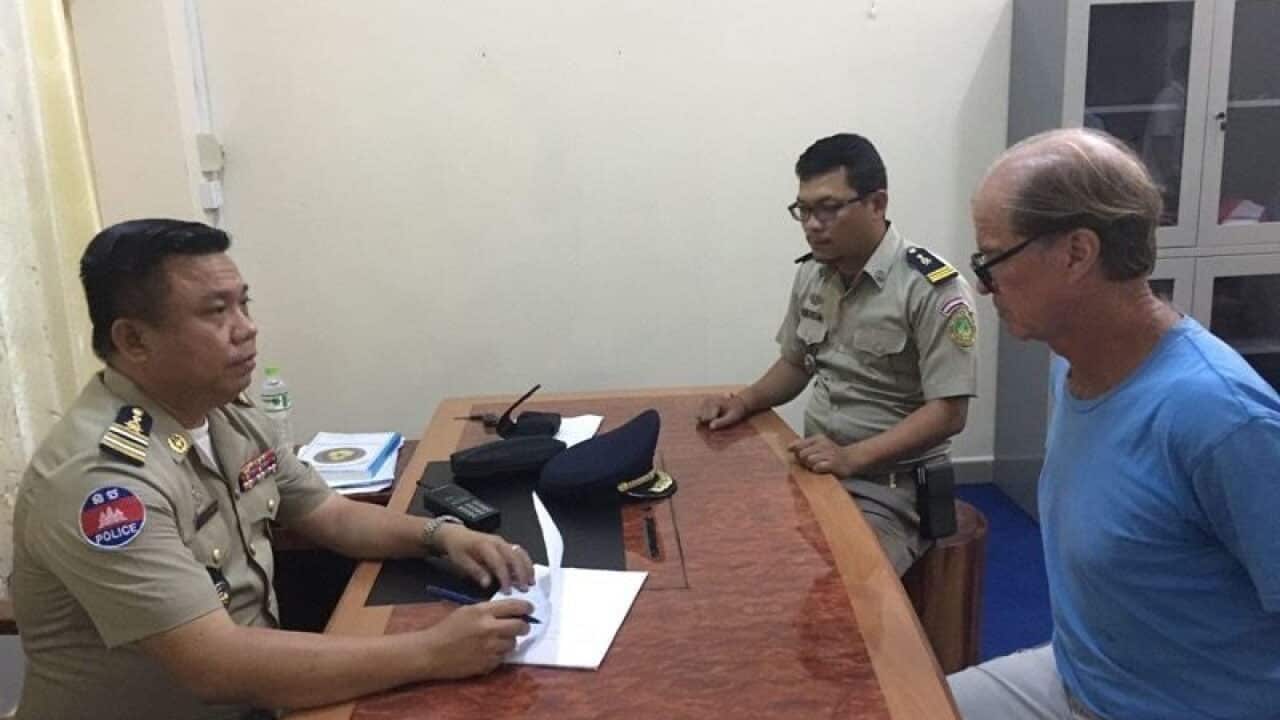 James Ricketson with Cambodian authorities.