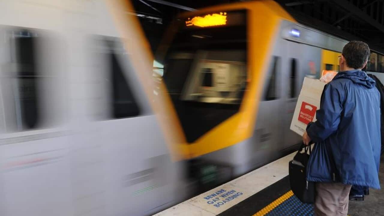 A Sydney train with man standing on the platform