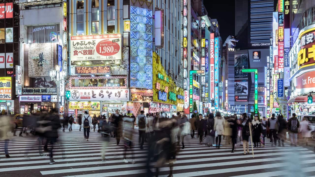 Busy Commuters in Shinjuku at Night and the view of Tokyo street / Tokyo, Japan