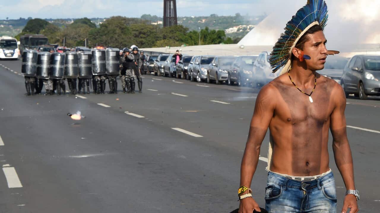 A Brazilian indigenous man clashes with police during the annual march for their rights, in Brasilia, on April 25, 2017.