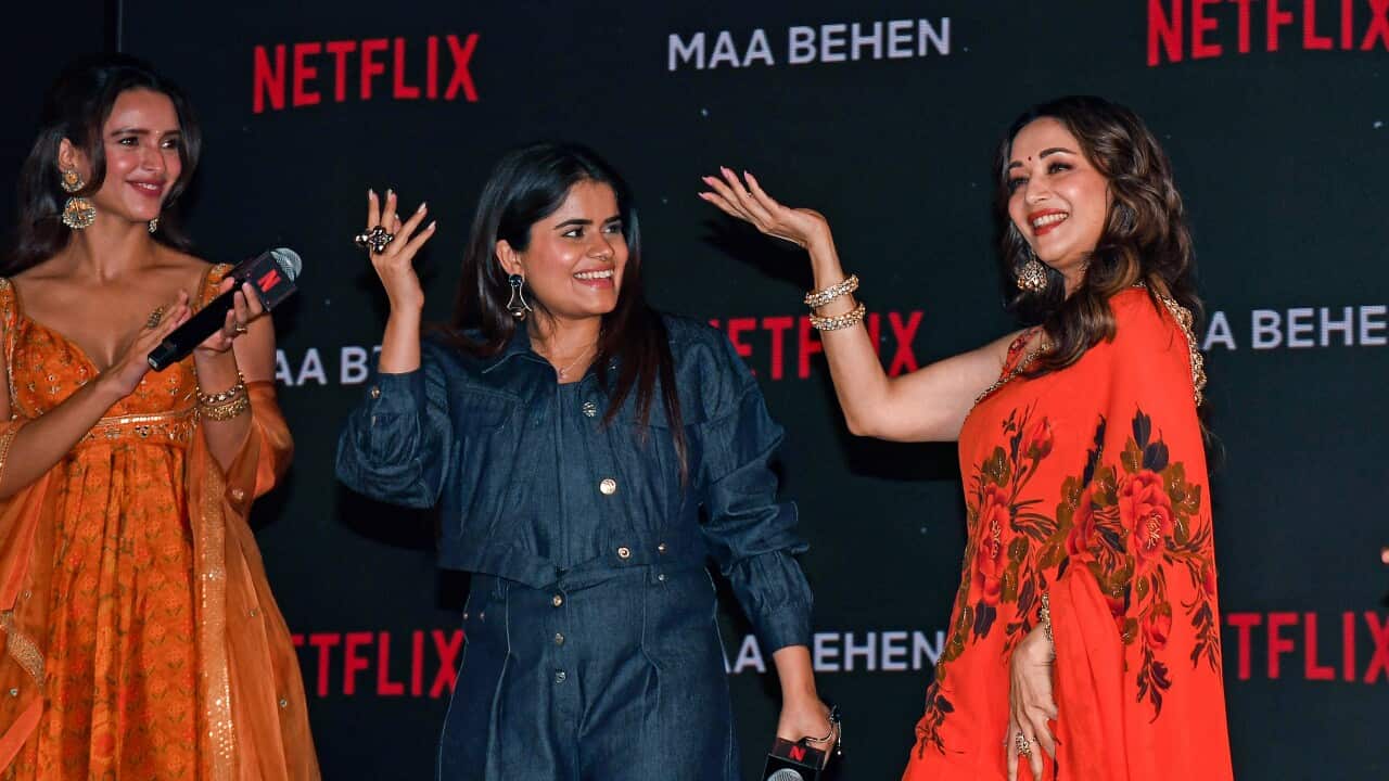 Bollywood actress Madhuri Dixit (R) dance as digital creator