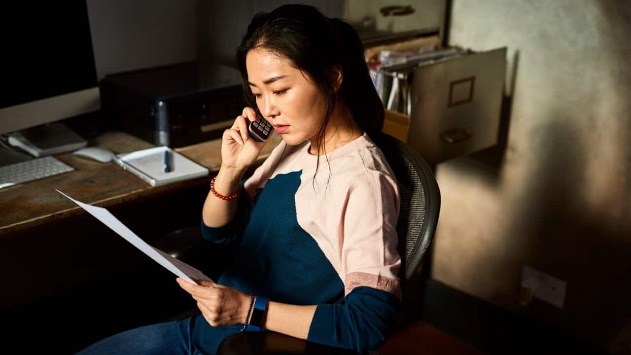 A woman sitting in office chair - Getty Images/10,000 Hours
