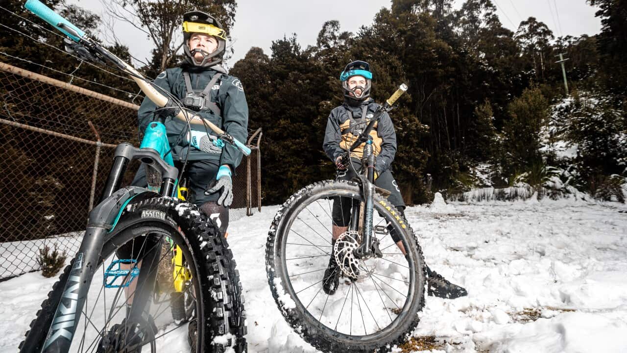 Cyclists pose or a photo at Mount Wellington in Hobart.