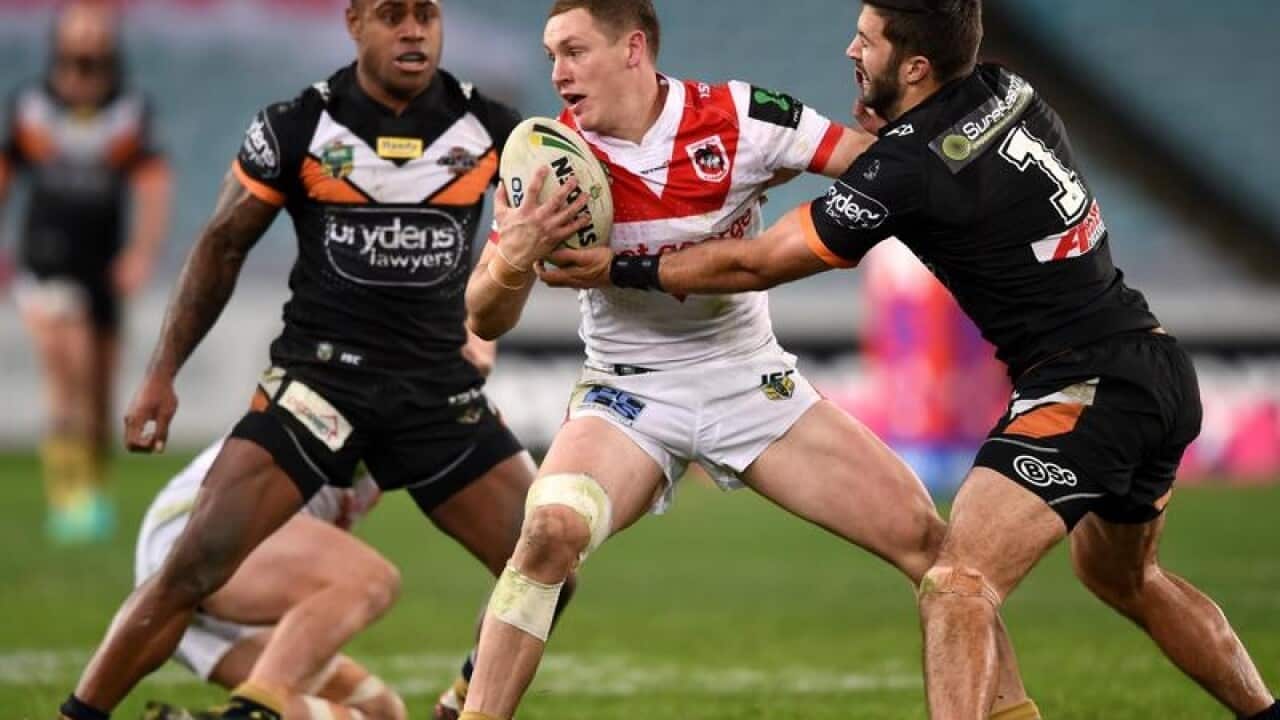 Kurt Mann of the Dragons is tackled.