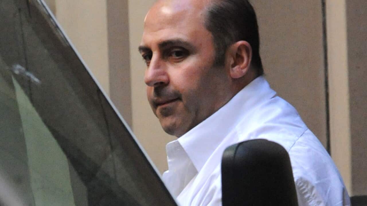 Tony Mokbel is lead into a prison van in Melbourne