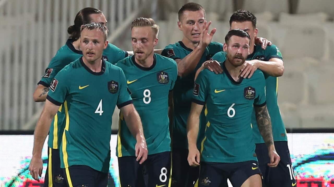 The Socceroos celebrate a goal against China