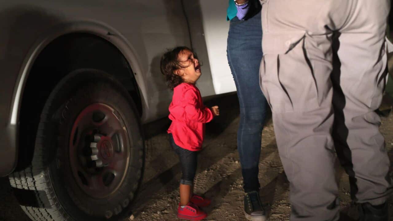 A two-year-old Honduran asylum seeker cries as her mother is searched and detained near the U.S.-Mexico border on June 12, 2018 in McAllen, Texas.