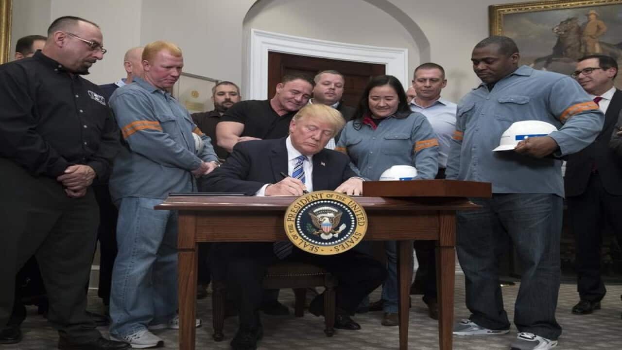 US President Donald Trump signs a proclamation on steel tariffs.