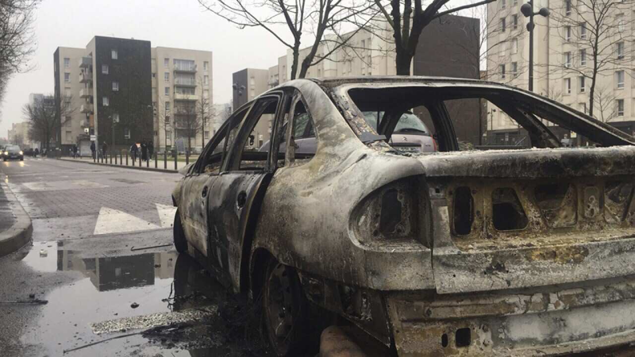 The remains of a car burnt by protesters in Aulnay-sous-Bois