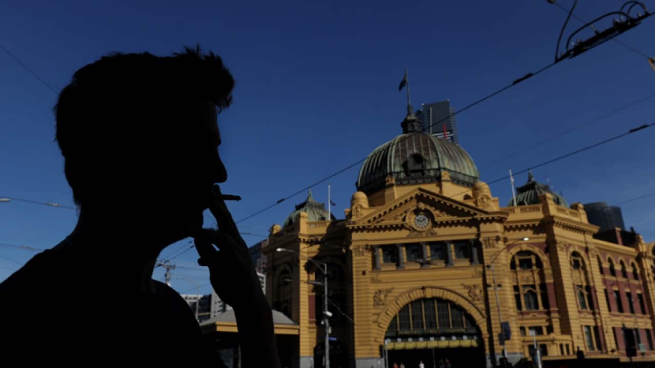 A person smokes outside Melbourne's Flinders Street Station