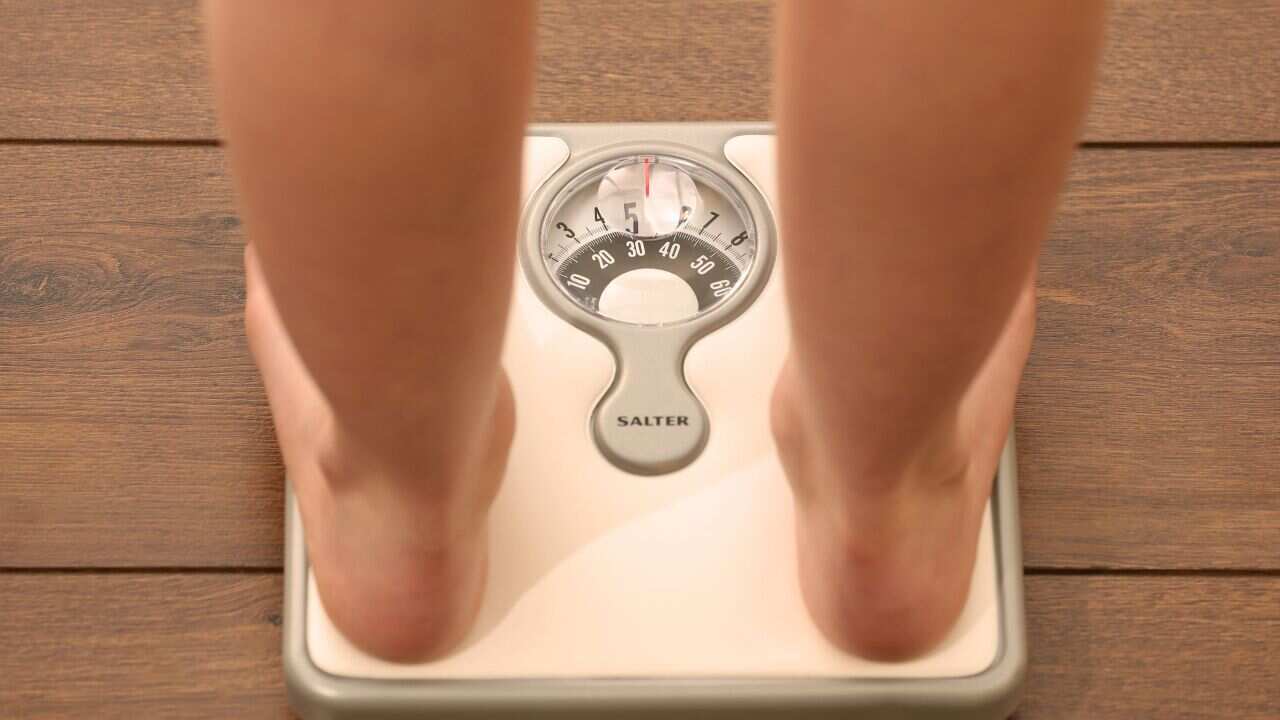 File photo dated 03/03/14 of a woman using a set of weighing scales as more must be done to help people who have lost weight to keep the pounds off, experts have said.. Issue date: Wednesday May 14, 2014. Interventions that help people keep the weight off