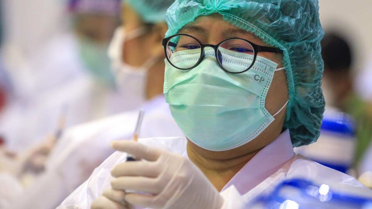 A Thai health official administers the Sinovac COVID-19 vaccine at a vaccination centre inside a shopping mall in Bangkok, Thailand, 31 May 2021.